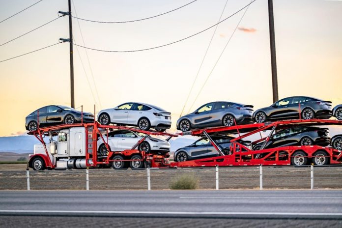 cars cars being shipped on a truck